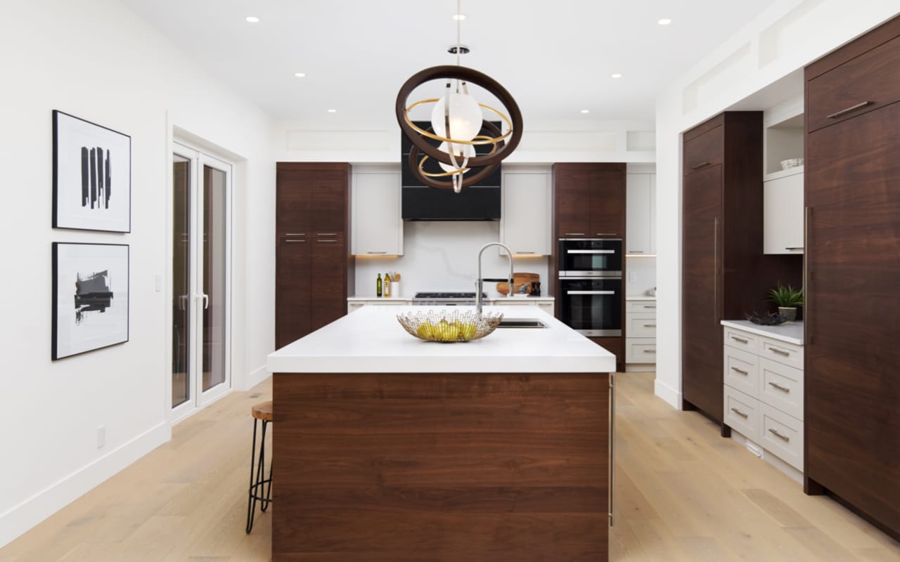 Contemporary kitchen with black and walnut slab-style cabinetry.
