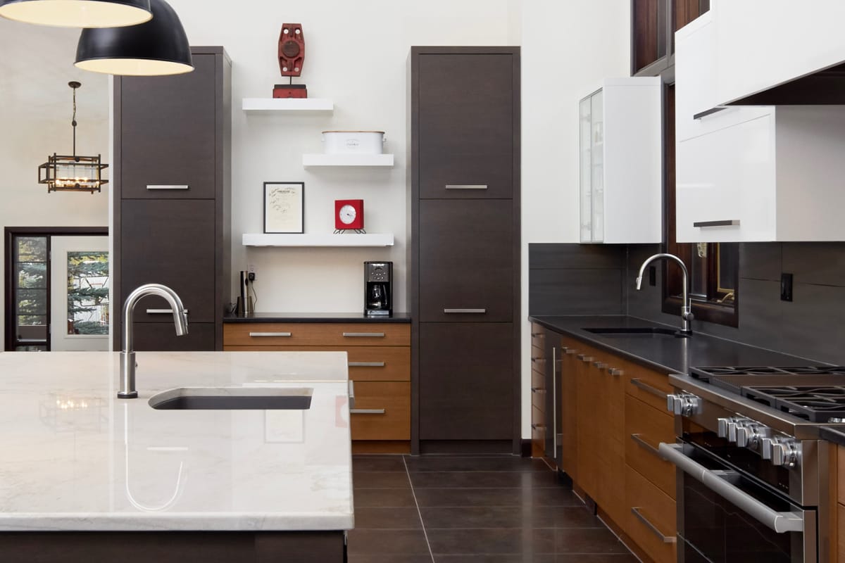 Contemporary kitchen with tri-color slab cabinetry.