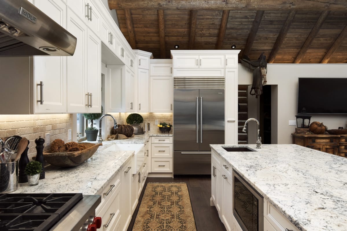 Traditional kitchen with rustic detailing including a wood ceiling.