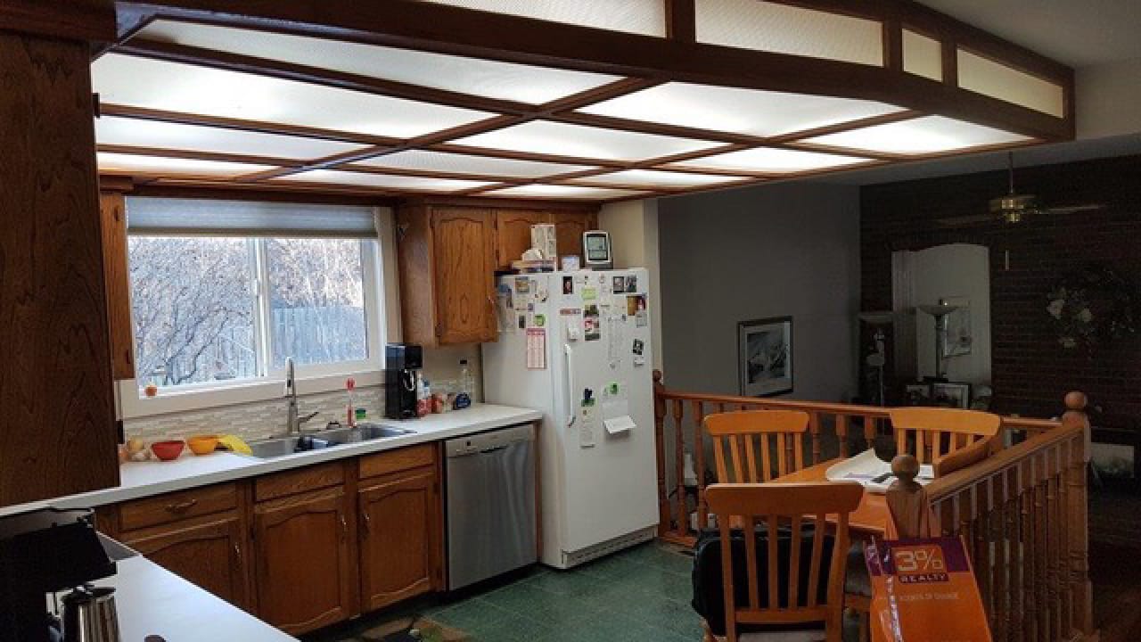 Before the renovation, this kitchen included green flooring, sunshine ceiling and dated cabinetry.