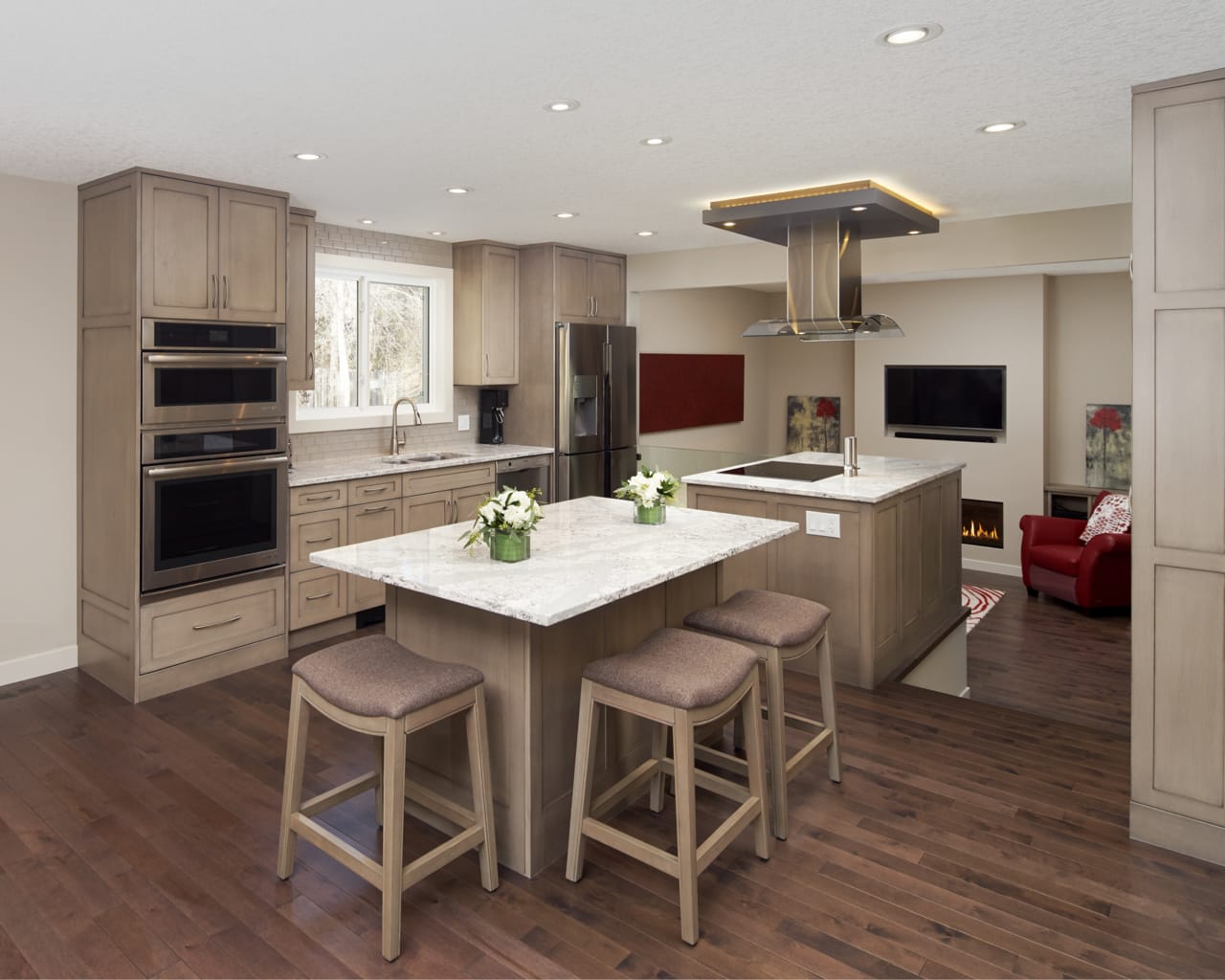 Neutral toned transitional kitchen with two islands.