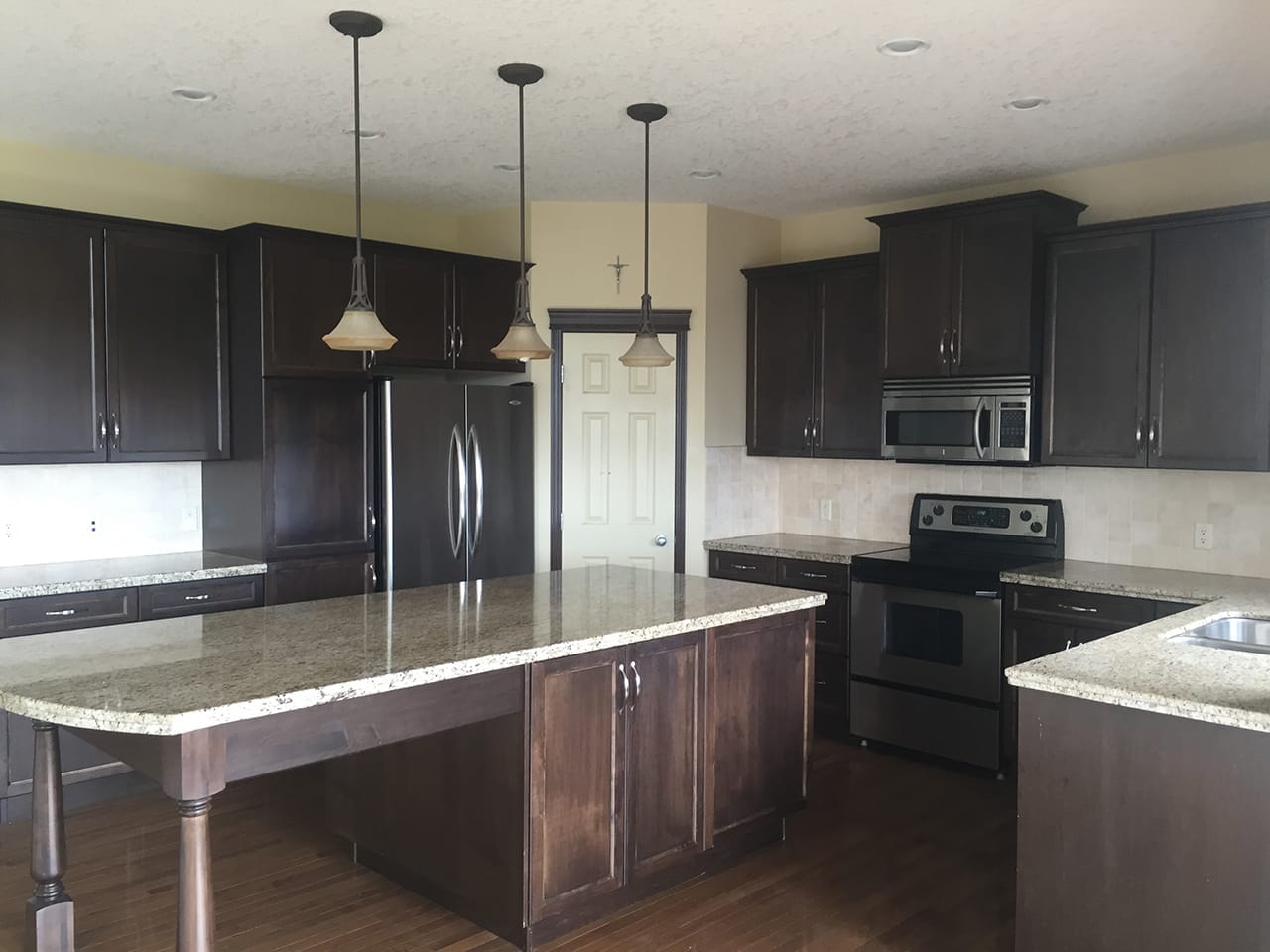 Dark wood tones made this kitchen feel heavy and dated.