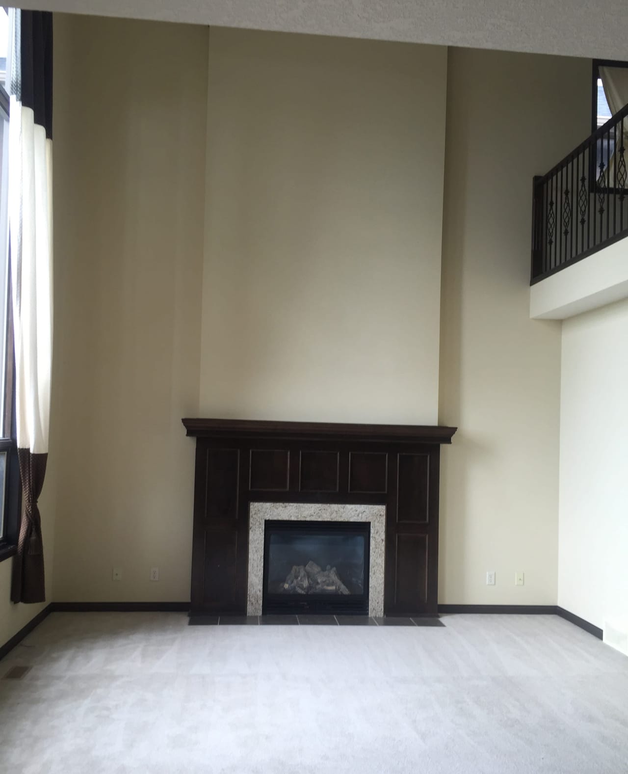 With the same wood stain as the kitchen cabinets, the old fireplace made the family room feel dark.