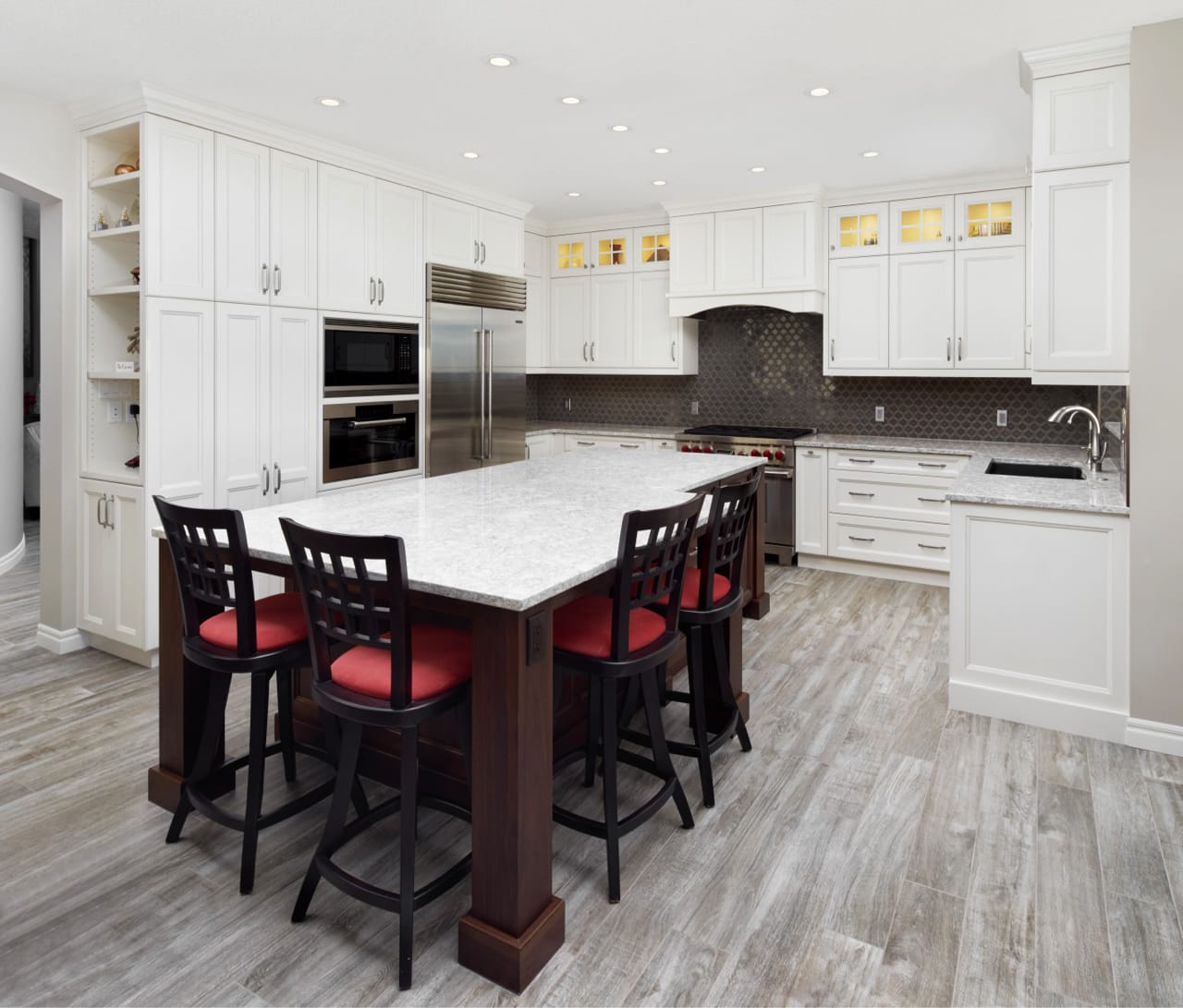 White shaker cabinets and a large kitchen island make this kitchen feel spacious and refreshed.