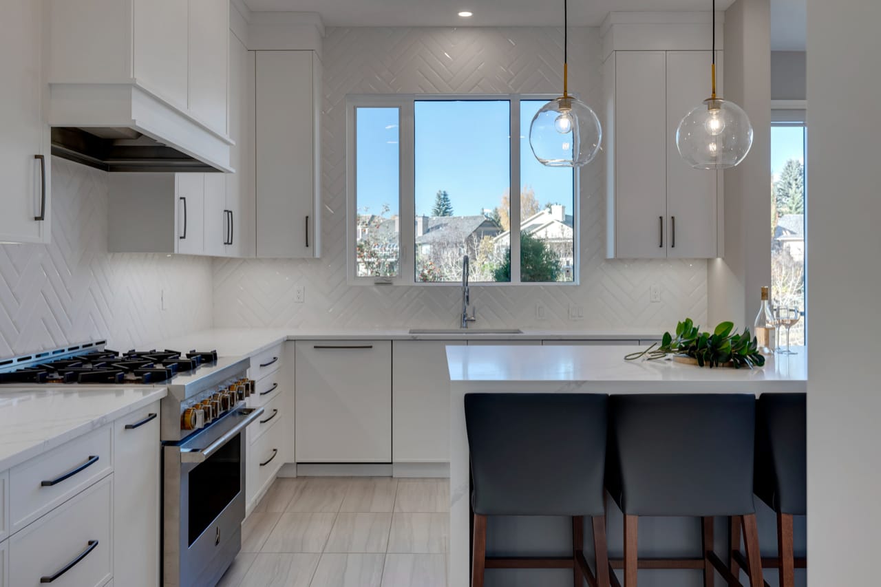 A grey rectangular replaced the previous kitchen island with improved seating and prep space.