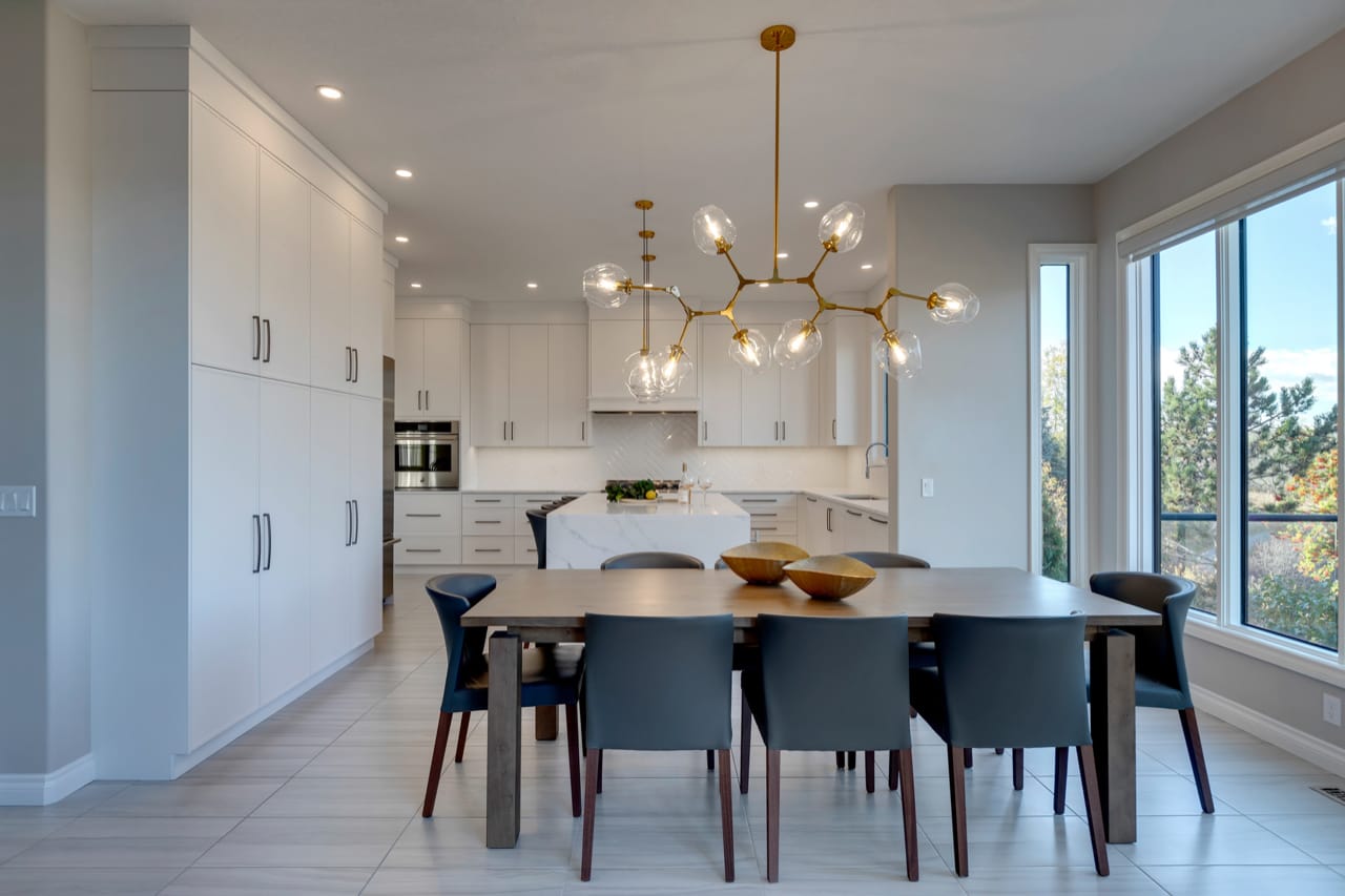 Bright white transitional kitchen with floor-to-ceiling cabinetry.