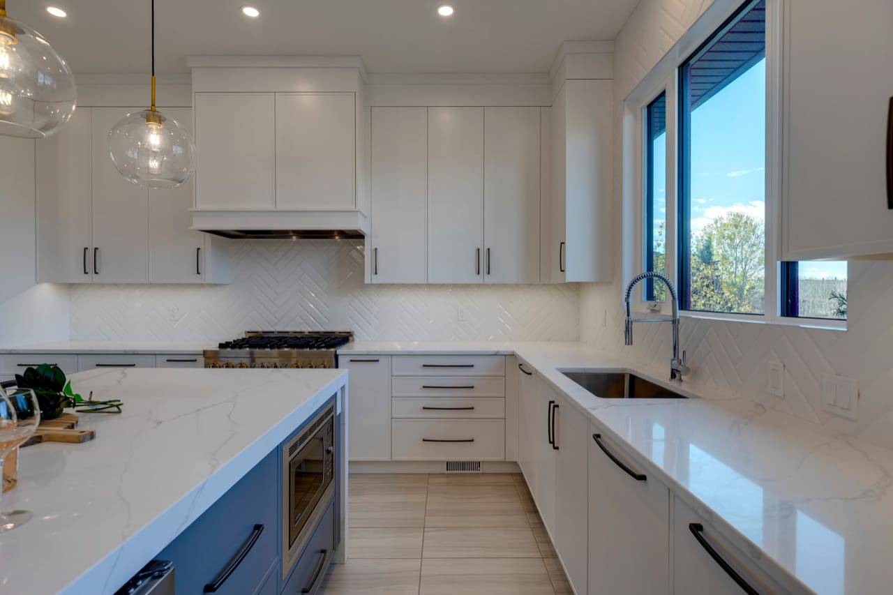 Two paneled dishwashers located beside the sink to improve cleanup.