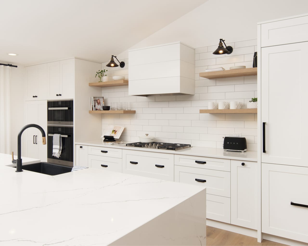 Floating shelves on either side of the hoodfan in a natural wood stain bring rustic charm to this kitchen.