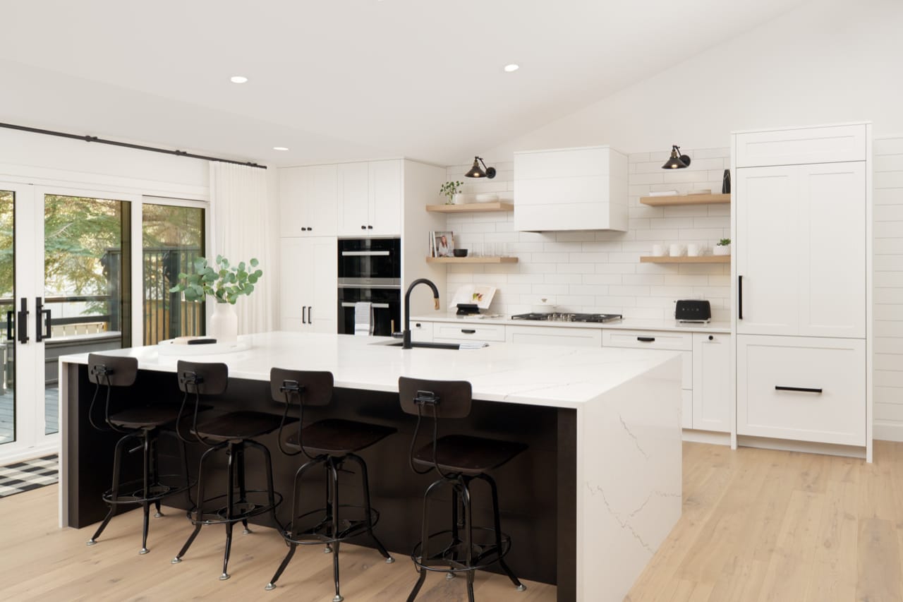 Matte black hardware and charcoal accents provide bold contrast with Chantilly Lace Cabinetry.