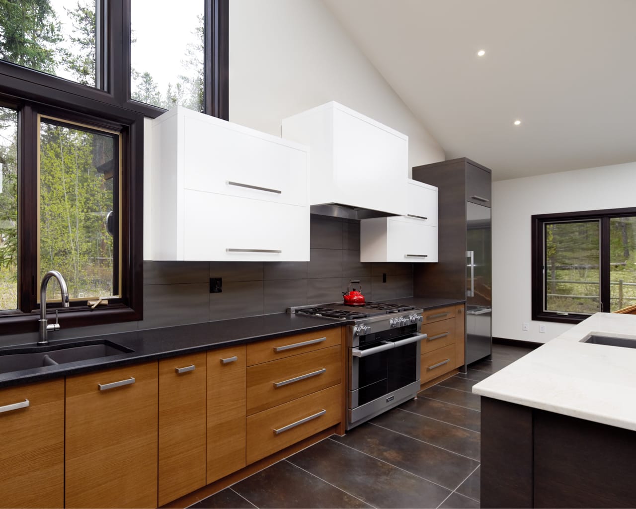 A combination of grey, walnut and white cabinetry give this kitchen a completely custom look.