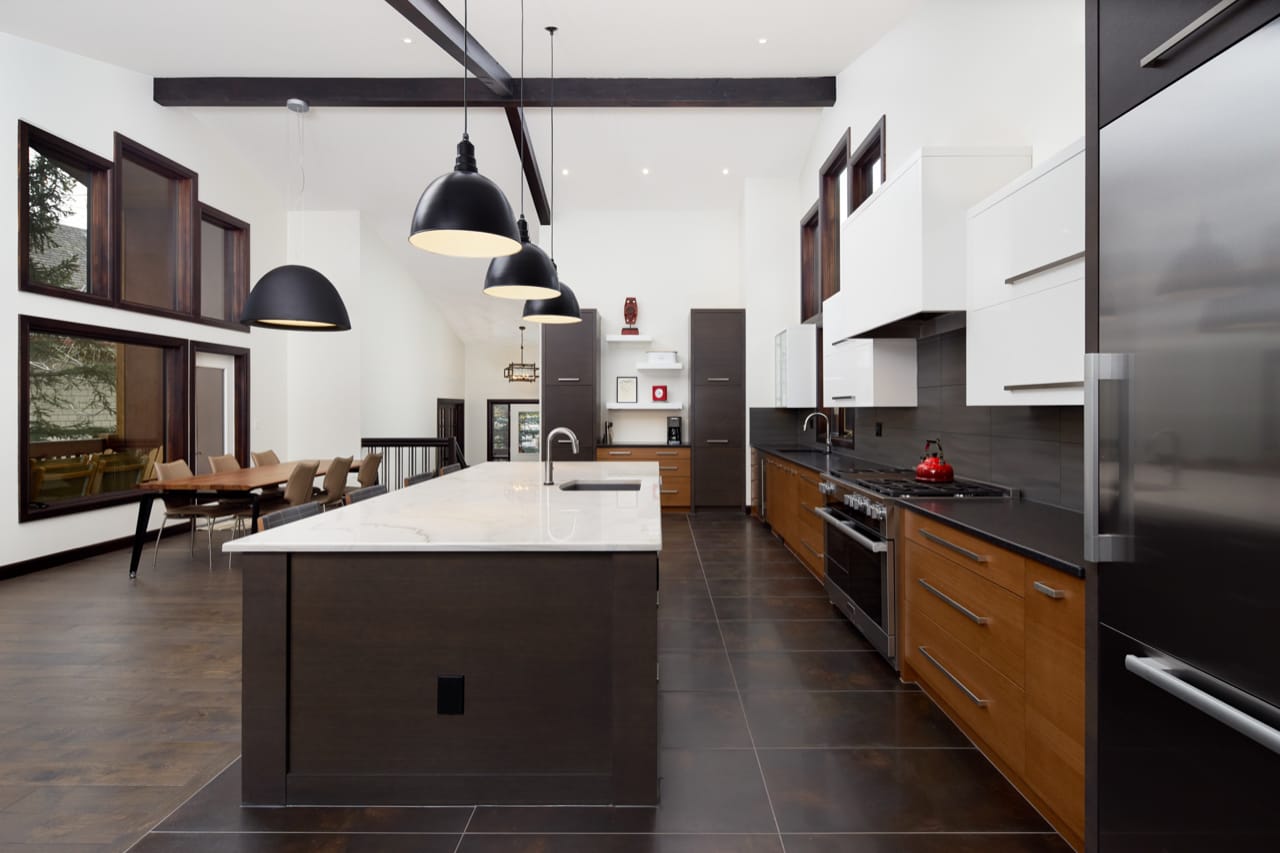 A sweeping kitchen with a long island and dining table creating several entertaining areas on the main floor of this home.