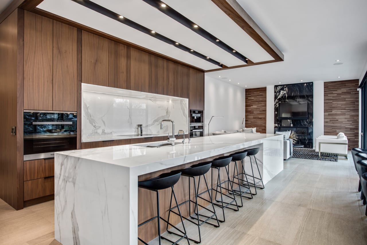 An extended kitchen island provides ample prep space and doubles as a stunning design feature.