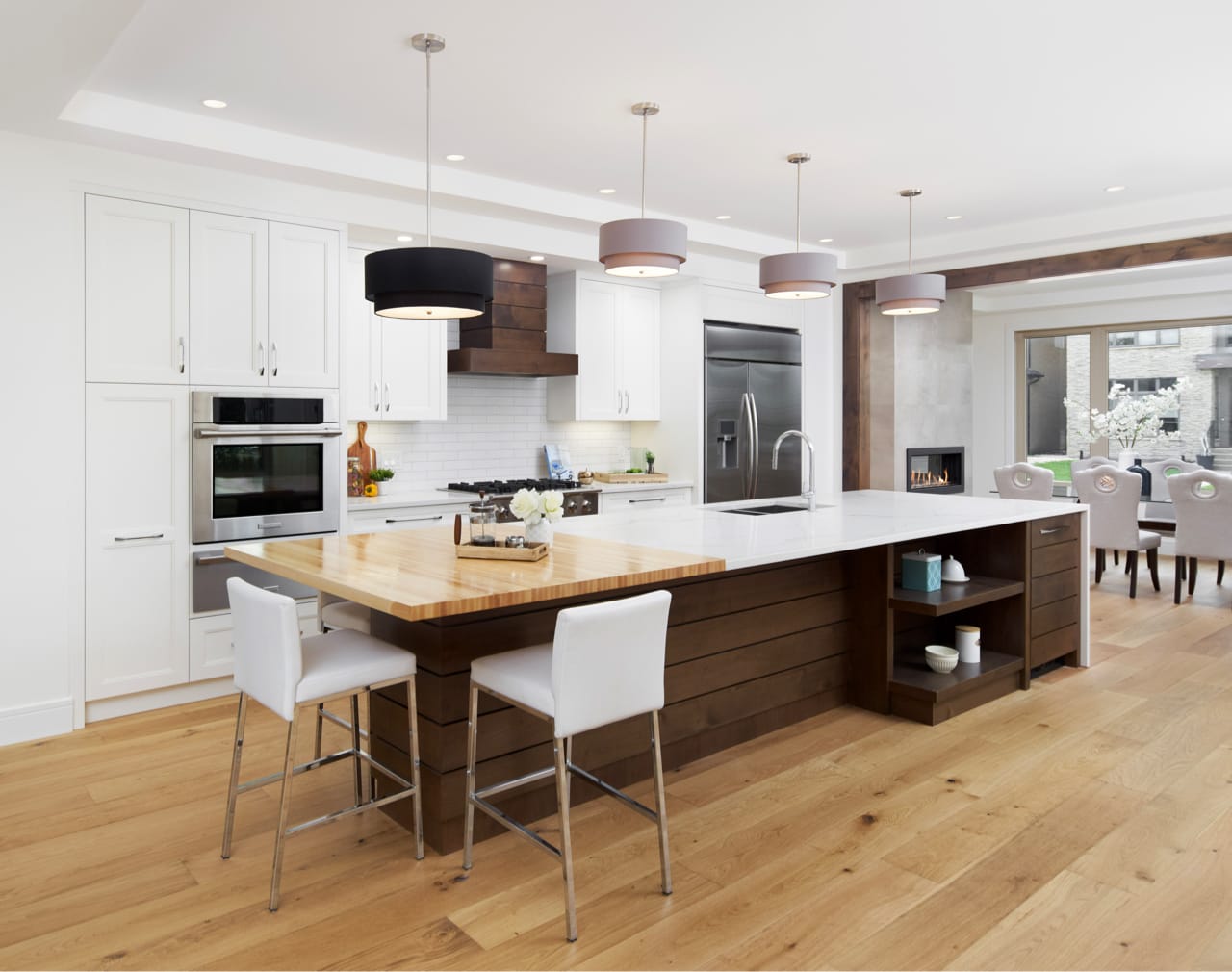 Transitional style kitchen with white shaker-style cabinetry and warm wood accents.