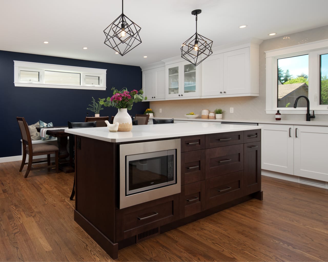 Large flat kitchen island with built-in microwave.